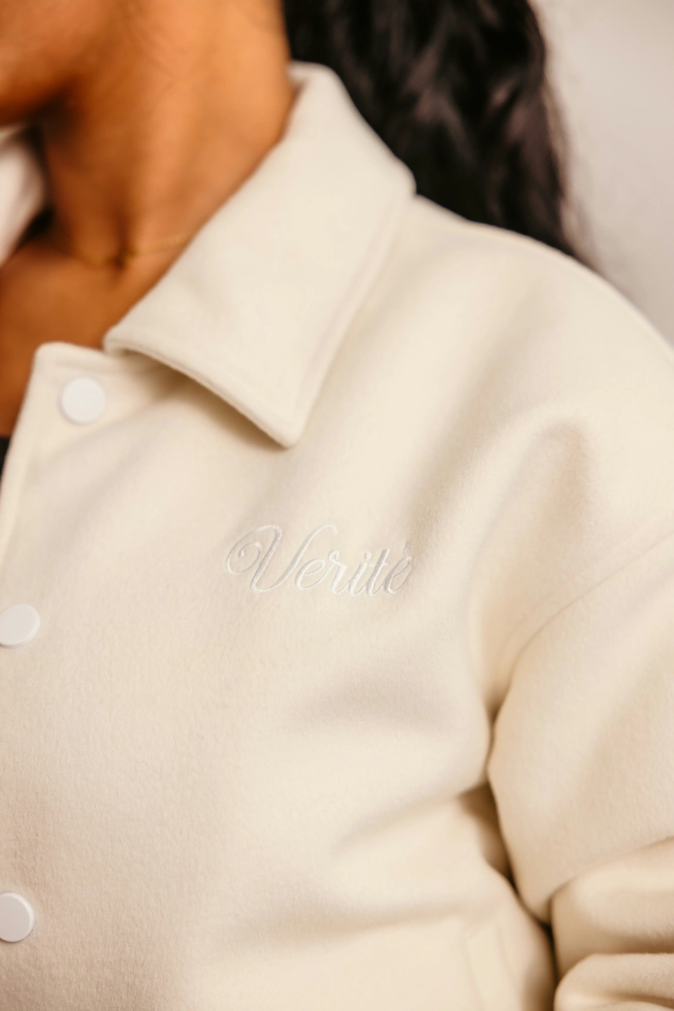Beige Globe Varsity Jacket — collar and front embroidery detail