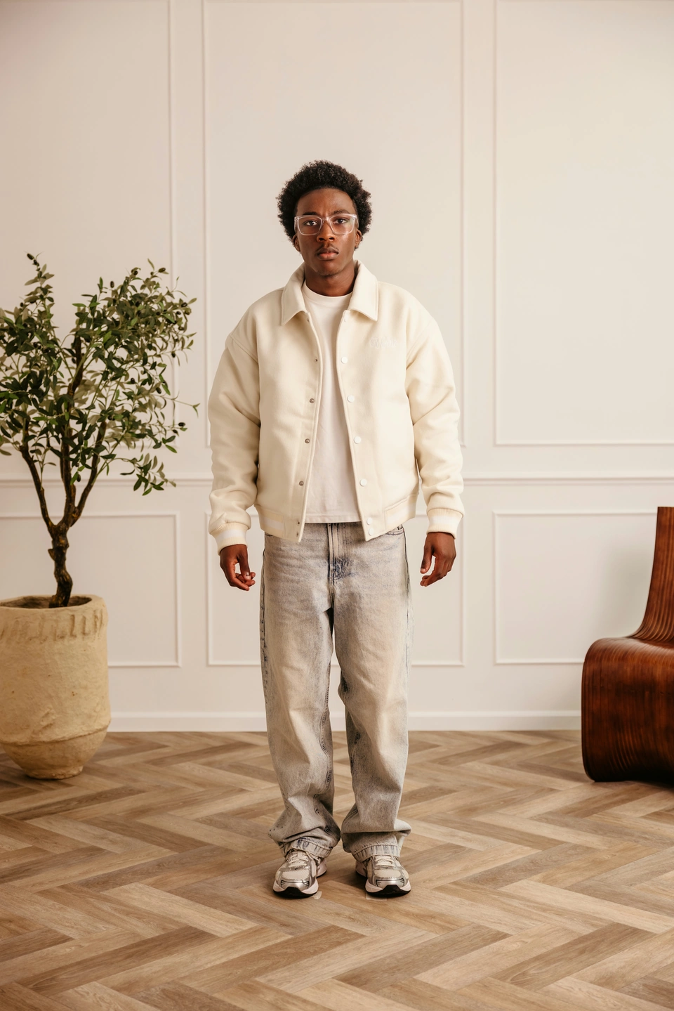 Beige Globe Varsity Jacket — male model, full-length front view