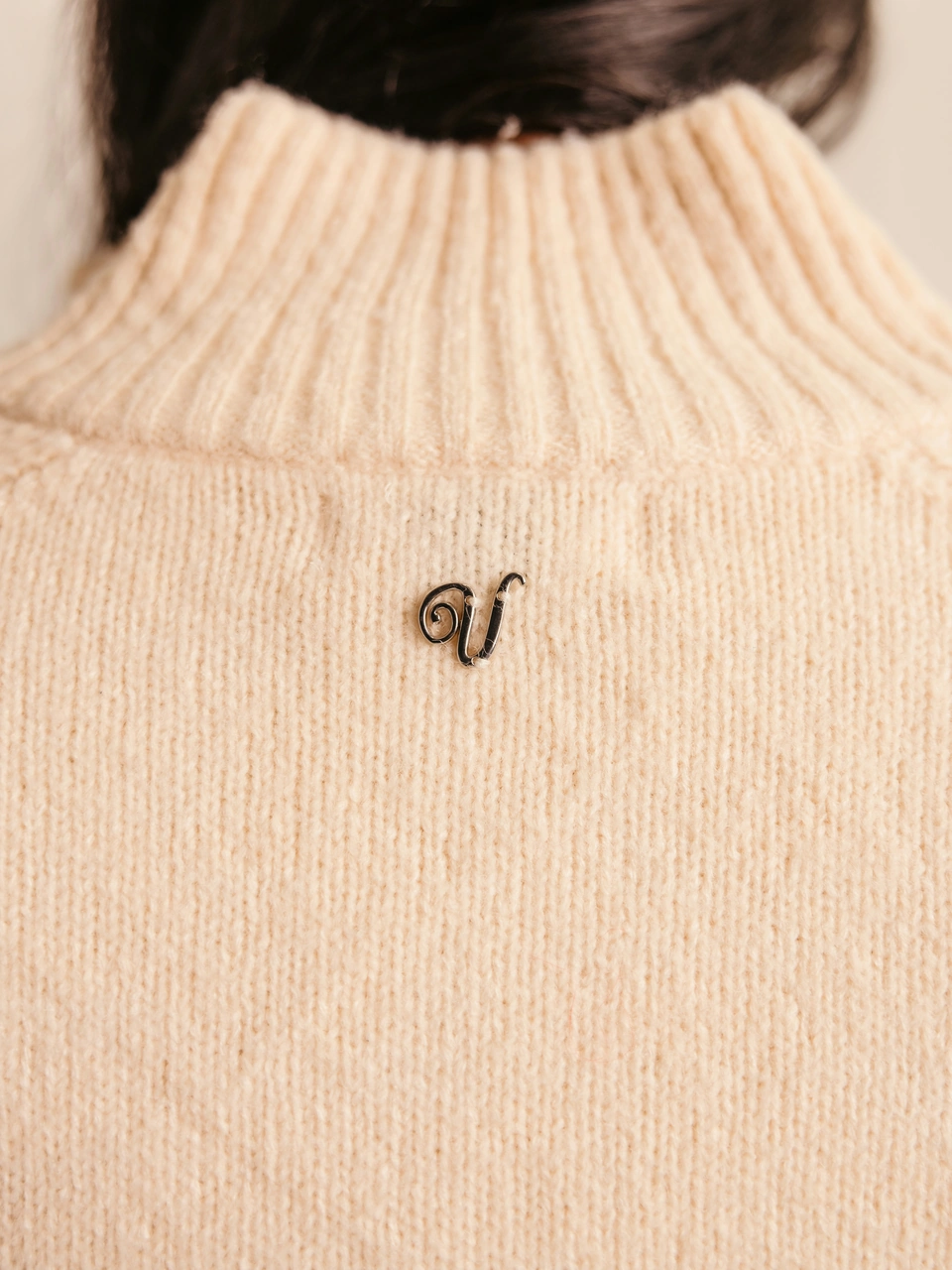 Ivory wool-blend zip-up cardigan — signature V-logo below the back collar