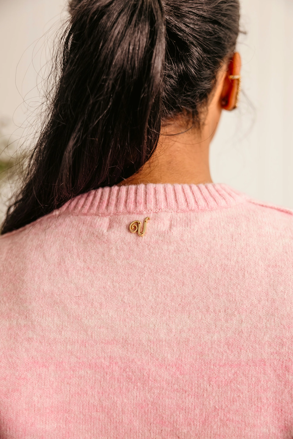 Soft Dawn Pink alpaca wool gradient knit sweater — back neckline and signature V-logo detail